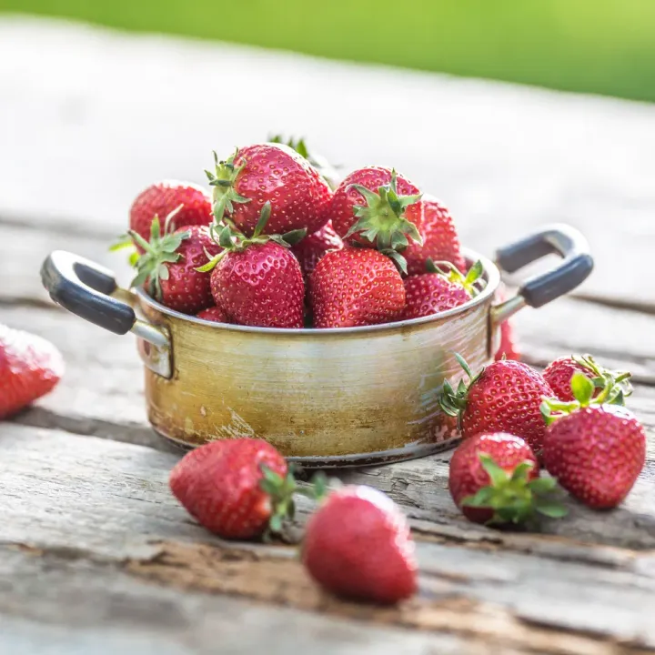 fresh strawberries in rustic bowl.