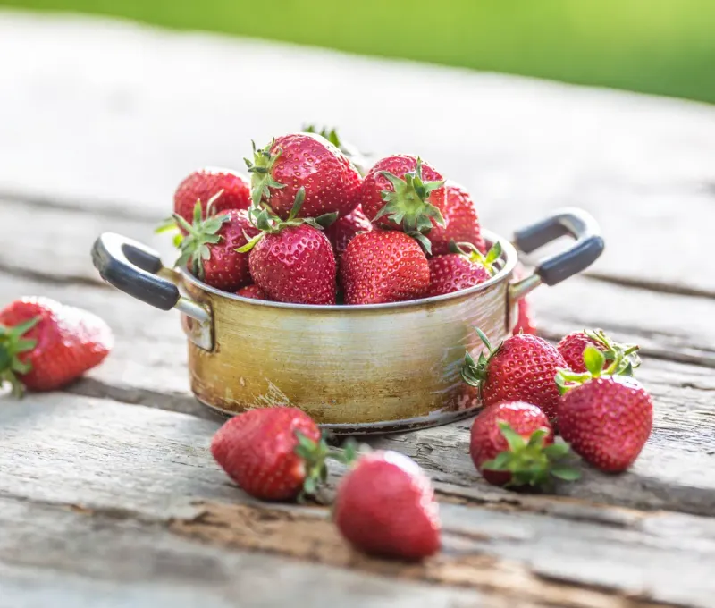 fresh strawberries in rustic bowl.